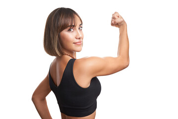 Brunette woman posing smiling in front of white background with yoga leggings and black sports tank top. Athletic woman posing smiling against a white background, showing off her muscles.