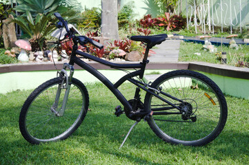 Fototapeta na wymiar Cross bike parked on the garden grass