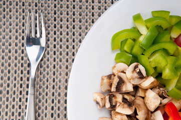 Close-up of diced mushrooms and green bell peppers