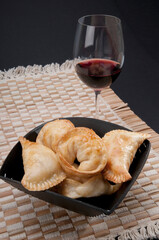 Close-up of a bowl of panzarotti served with red wine