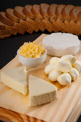 High angle view of assorted cheeses served with bread