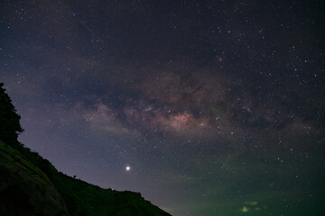 Fototapeta na wymiar Long exposure Night Photography with Milky way over mountain in phuket thailand.