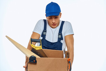 A man in a working uniform with a box in his hand loading a delivery service