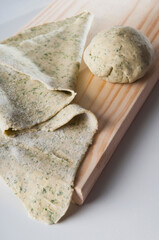 High angle view of dough on a cutting board