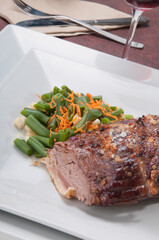 Close-up of baked meat served with salad