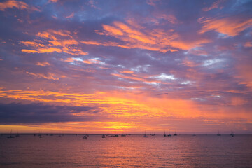 Moored sailing boats and yacht in Darwin Harbour at sunset. Darwin, Northern Territory, Australia.