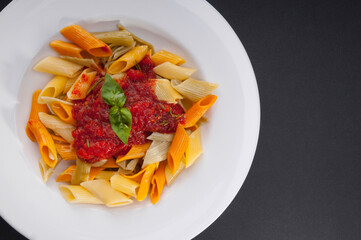 High angle view of rigatoni pasta topped with tomato concasse