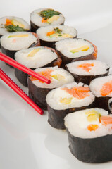 Close-up of sushi rolls with chopsticks