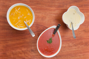 High angle view of bowls of assorted soups