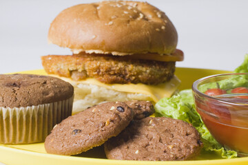 Close-up of a cupcake and cookies with a hamburger