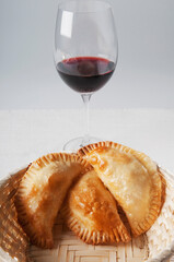 Close-up of a basket of panzarotti served with red wine