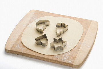 Pastry cutters with dough on a cutting board