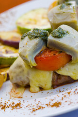 Close-up of fish on steaks with grilled vegetables