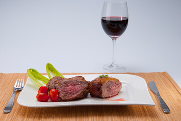 Close-up of steak served with red wine