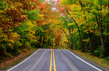 Highway through Gorgeous fall colors in Michigan