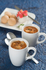 Two cups of tomato soup with bread cubes
