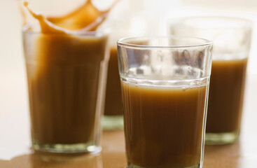Close-up of tea splashing in glasses
