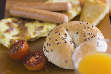 High angle view of an omelet served with frankfurters and a bagel