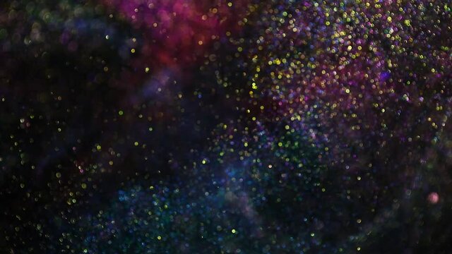 Decoration bokeh glitters background video. Abstract sparkle backdrop with circles in motion. Footage with liquid twinkling particles. Animation with pink, blue and golden colors with blur effect