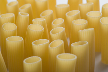 Fototapeta premium Close-up of raw rigatoni on a white background