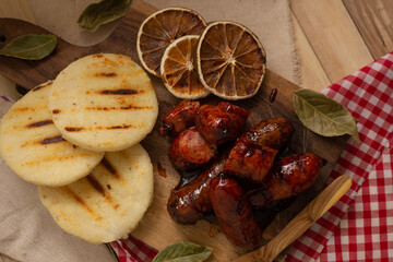 Arepa and sausage ​​served on a table