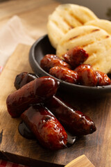 Arepa and BBQ sausage ​​decorated on the table