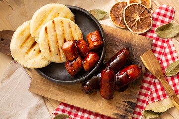 Arepa and BBQ sausage ​​decorated on the table