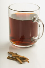 Close-up of a cup of herbal tea with cinnamon sticks