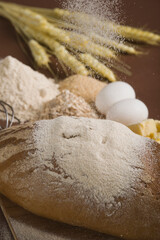 Close-up of a loaf of bread with eggs on a cutting board
