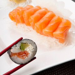 Close-up of sushi held with chopsticks