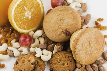 Close-up of nuts and fruits with cookies and muffins