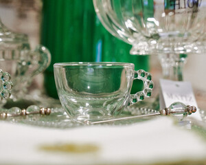 Transparent teacup and green teapot