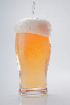 Close-up of an overflown beer glass