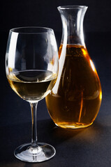 Close-up of a glass of white wine with a jar