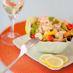 Close-up of shrimp salad served with white wine
