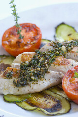 Close-up of fish steaks on grilled zucchini