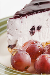 Close-up of blueberry cheesecake with glazed grapes