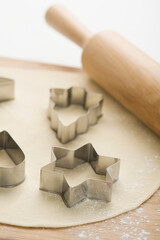 Pastry cutters with dough on a cutting board