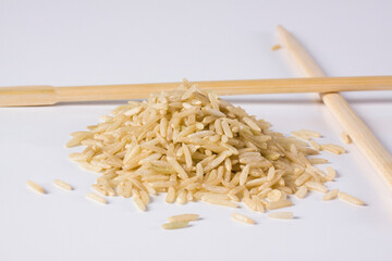 Close-up of brown rice with chopsticks