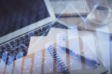 Double exposure of financial chart drawing and desktop with coffee and items on table background. Concept of forex market trading