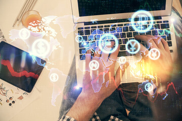 Double exposure of man's hands typing over laptop keyboard and forex chart hologram drawing. Top view. Financial markets concept.