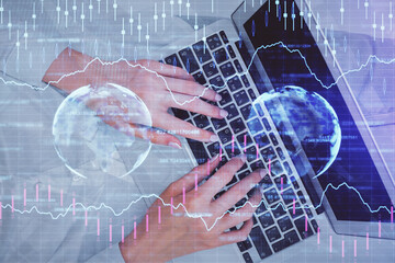 Double exposure of woman hands working on computer and forex chart hologram drawing. Top View. Financial analysis concept.
