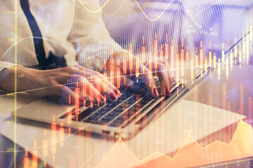 Multi exposure of woman hands typing on computer and financial graph hologram drawing. Stock market analysis concept.
