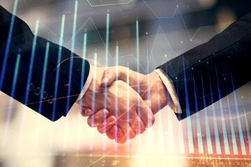 Double exposure of forex graph hologram and handshake of two men. Stock market concept.