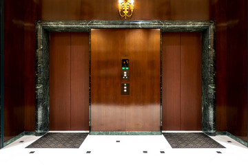 Front of Two close elevators in  old retro style Hotel