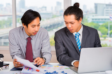 Asian Business colleagues in conference meeting room during presentation.