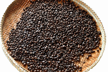 Roasted coffee beans in a bamboo basket