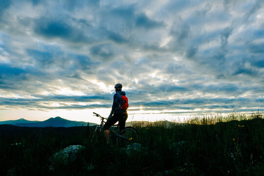 Active young woman biking on a mountain