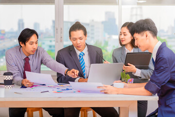 Business professionals. Group of young asian confident business people analyzing data using computer while spending time in the office.