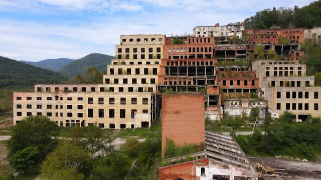 View from above. The camera flies past the abandoned plant of the Khrustalnensky mining and processing plant in the village of Khrustalny, Primorsky Territory. Abandoned tin mining plant